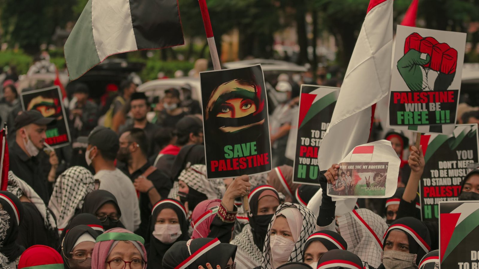 crowd of people protesting with banners